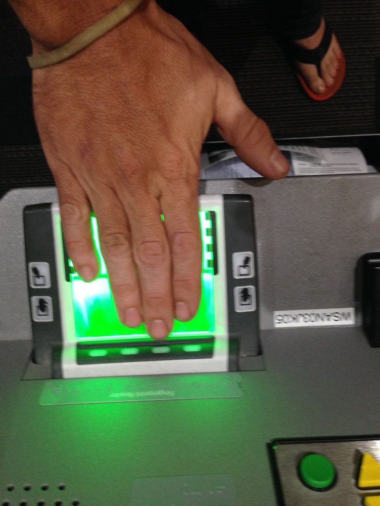 Hand being scanned on a digital livescan fingerprint scanner