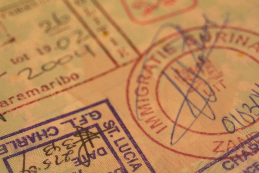 Passport pages filled with international immigration stamps