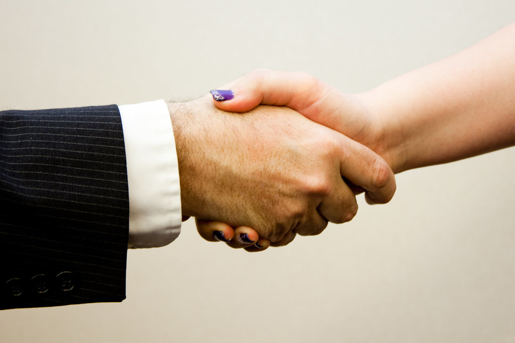 Business handshake confirming an on-site corporate service engagement
