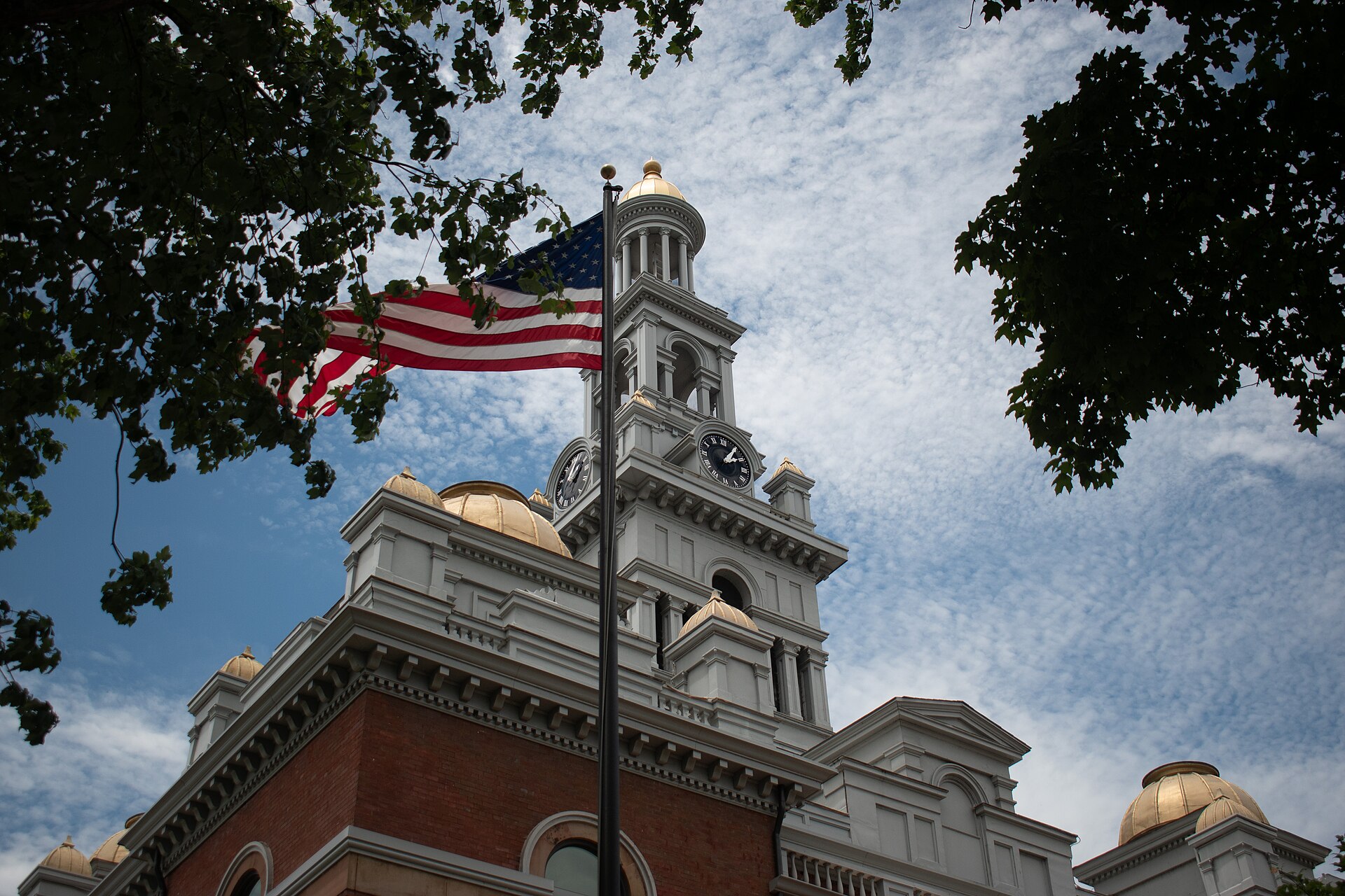 United States flag flying in front of a courthouse building